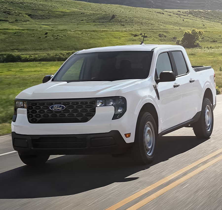A 2025 Ford Maverick® pickup in Oxford White driving on a country highway