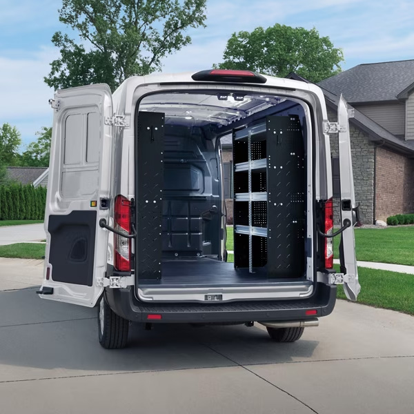 2025 Ford Transit parked in residential driveway with rear doors open