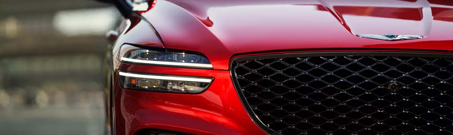 Exterior shot of the headlight and grille on a Genesis GV70.