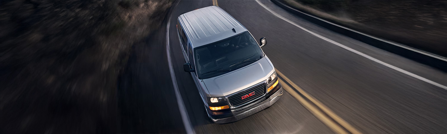 Overhead shot of the 2025 GMC Savana Cargo Van driving down winding road