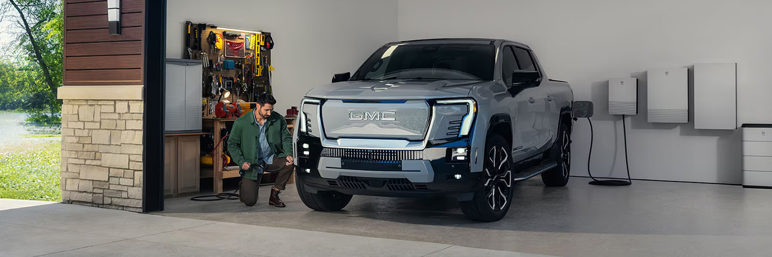 The 2025 GMC Sierra EV Pickup Truck Parked and Charging in a Home Garage