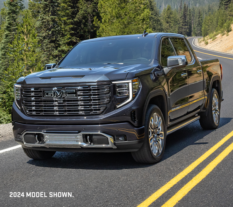 2024 GMC Sierra 1500 Denali Ultimate Crew Cab Short Box 3/4 Drivers side Front with Mountains in background