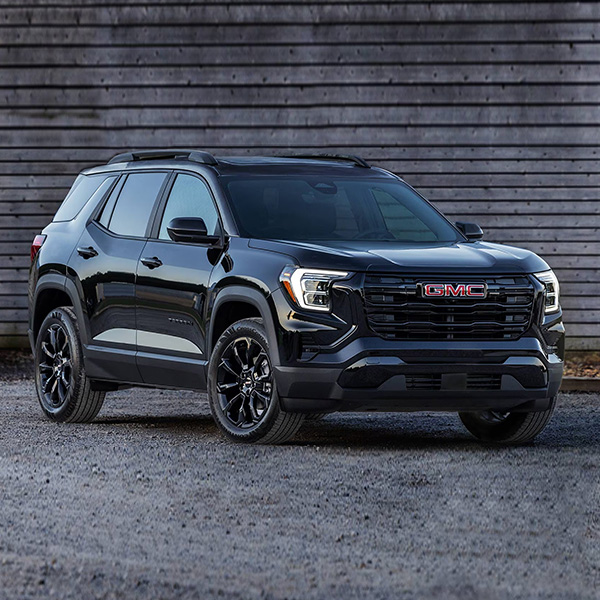 Front Three-Quarters View of the GMC Terrain Small SUV Parked in Front of a Building