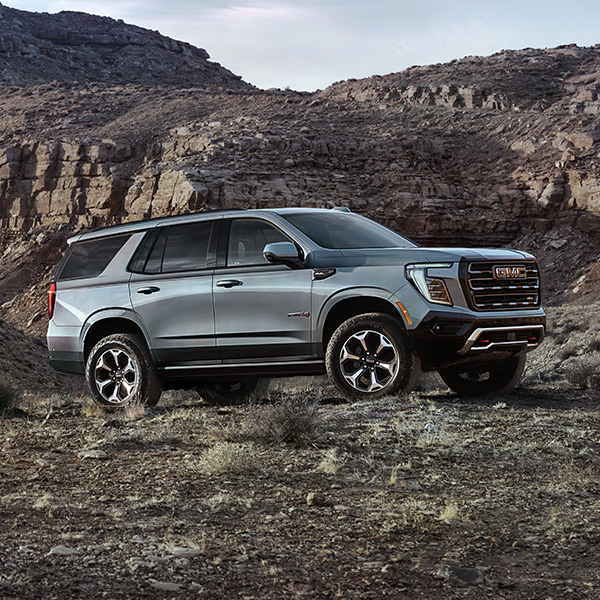 Side profile shot of the 2025 GMC Yukon parked on rocks