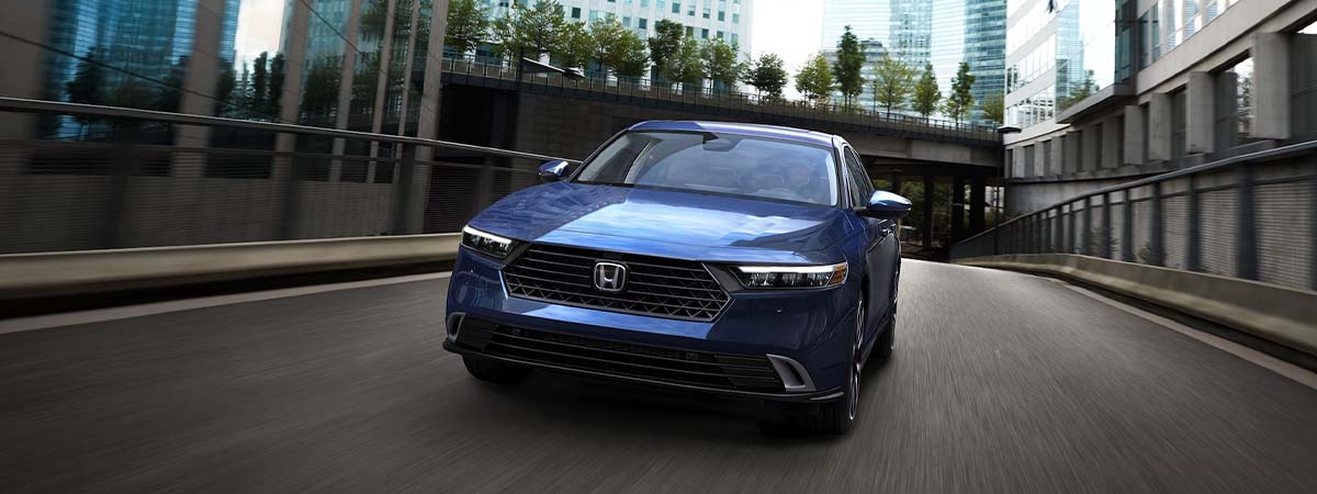 Blue 2025 Honda Accord racing down an urban street