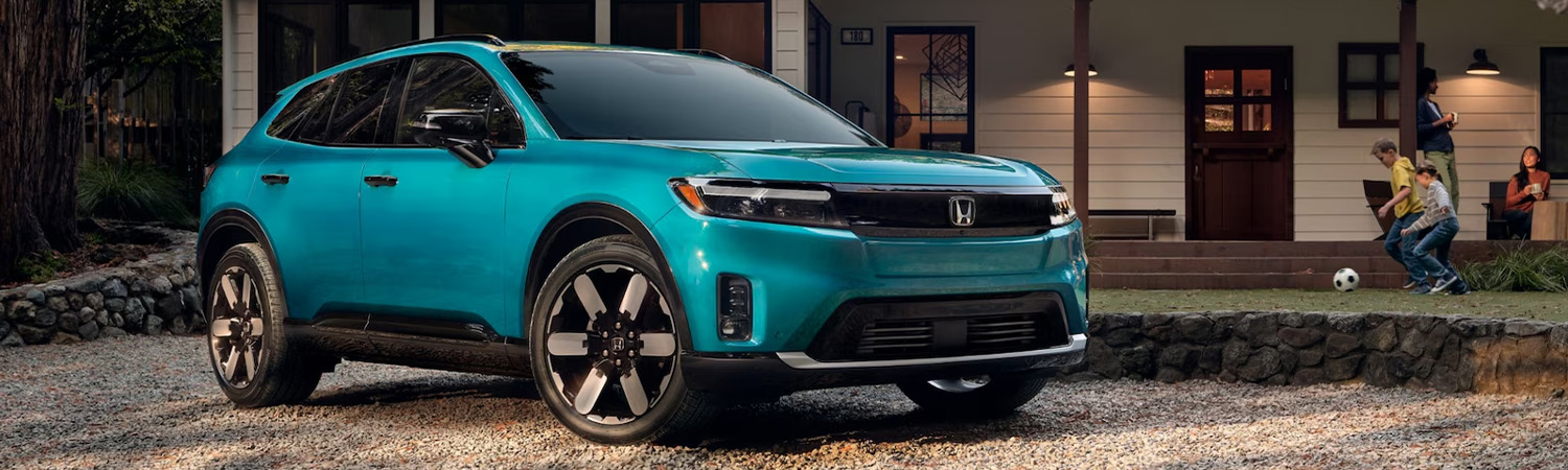 External shot of a parked 2025 Honda Prologue in front of a house.
