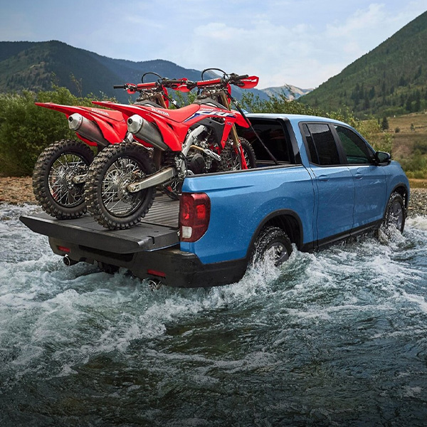 Rear view of Honda Ridgeline carrying dirt bikes
