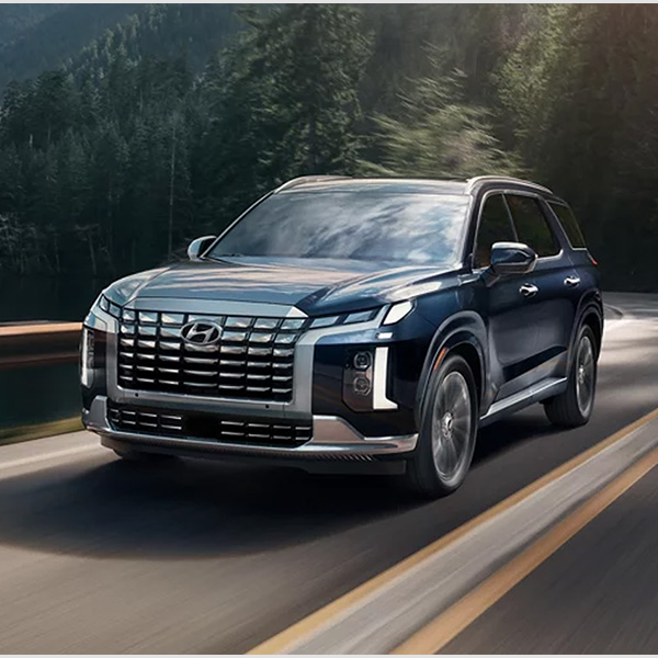 2025 Hyundai Palisade front 3/4 view driving on a road.