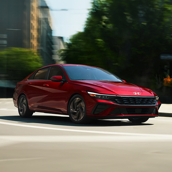 The 2025 Hyundai Elantra taking a turn on a road