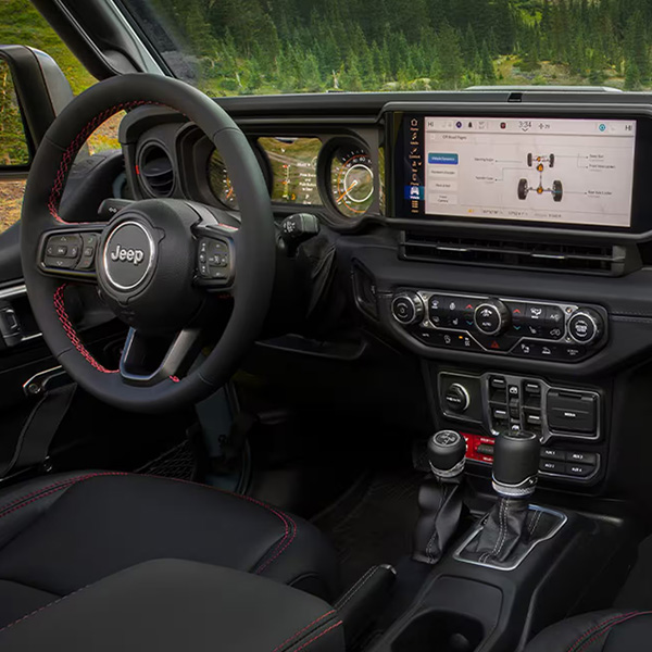 Display The steering wheel, Uconnect touchscreen and center stack controls in the 2025 Jeep Gladiator.