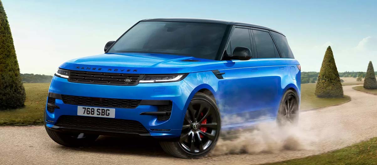 A Blue 2025 Range Rover Sport racing down a dirt road