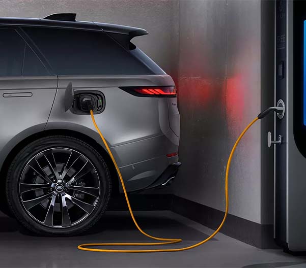 View of the 2025 Range Rover Sport charging at a station