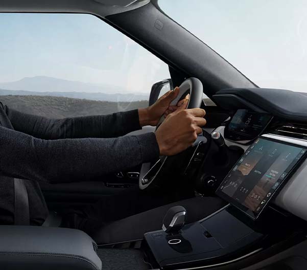 Hands on the steering wheel of the 2025 Range Rover Sport