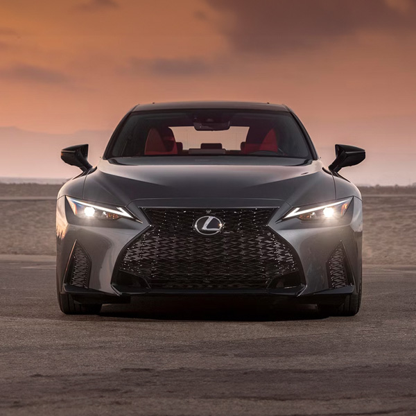 Head on shot of the 2025 Lexus IS parked in front of beach