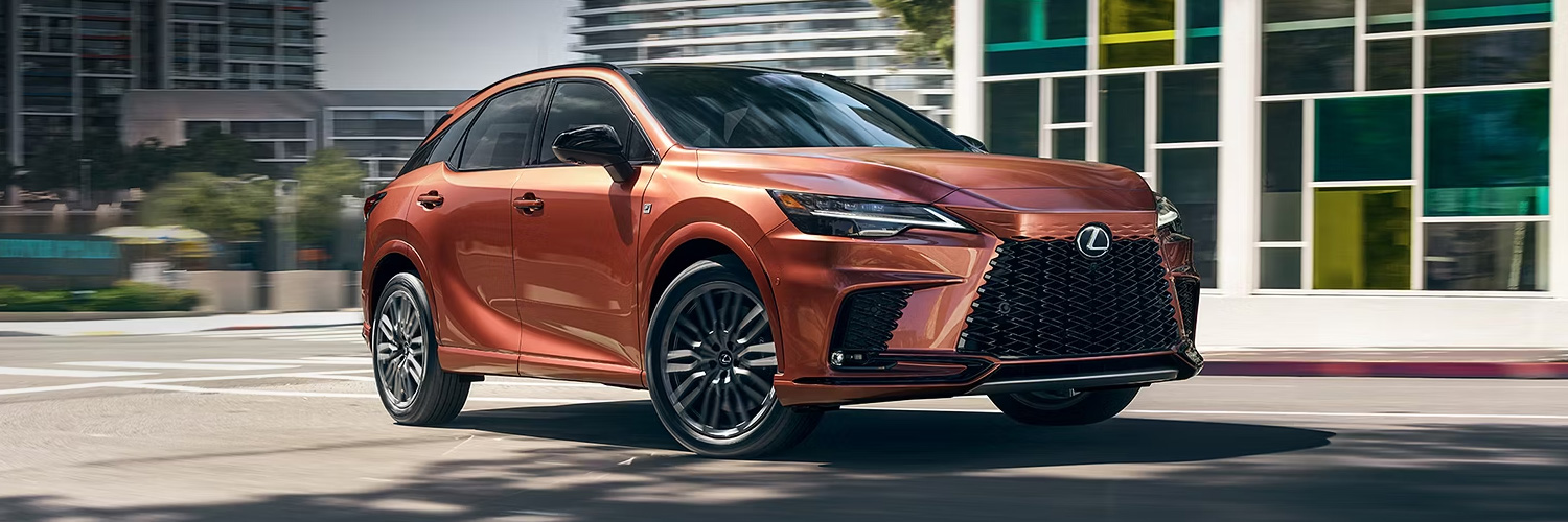 Front 3/4 shot of the 2025 Lexus RX driving down city street