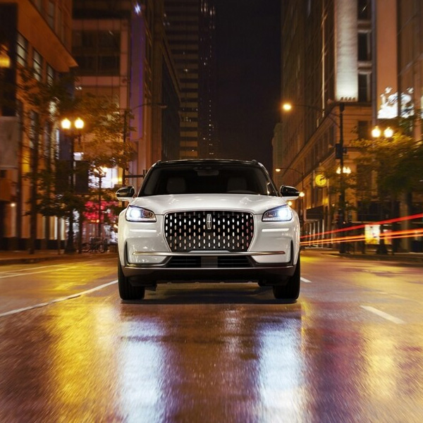 Environmental neon light bounces off the grille of a 2025 Lincoln Corsair® Reserve SUV