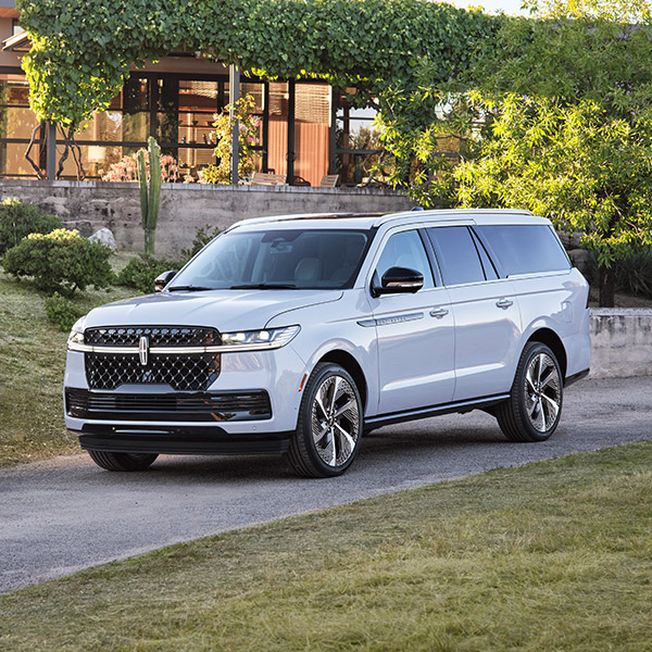 Front 3/4 shot of the 2025 Lincoln Navigator parked in front of house