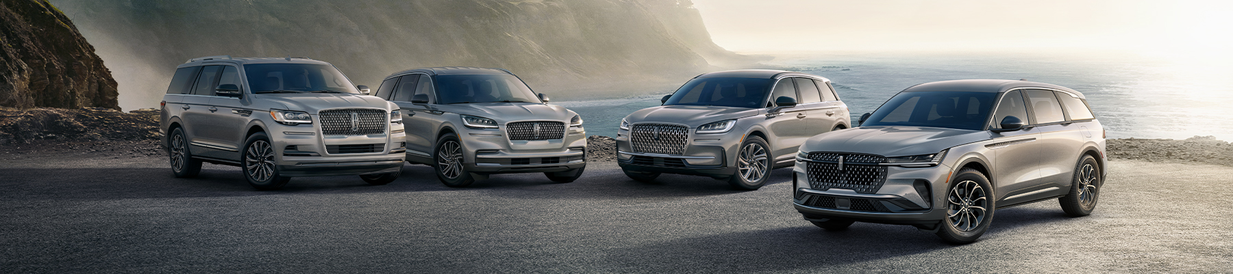 2025 Lincoln Aviator driving down the road with trees in the background