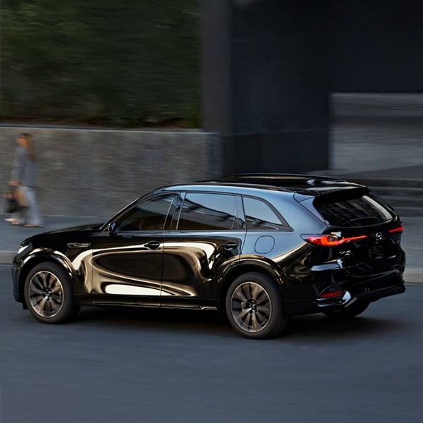 2025 Mazda CX-70 driving on city street.