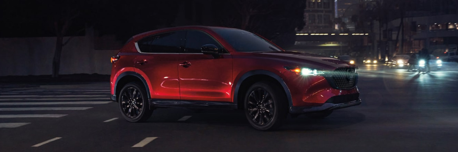 2025 MAZDA CX-5 driving at night in a city.
