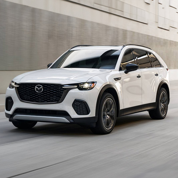 2025 MAZDA CX-70 PHEV driving on a highway.