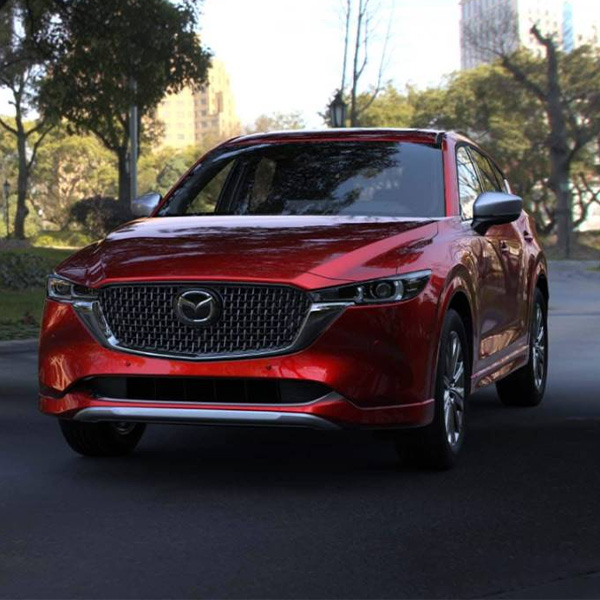 2025 MAZDA CX-5 driving on a street.