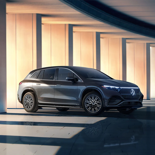 Side profile view of the 2025 Mercedes-Benz EQS SUV parked in a modern garage