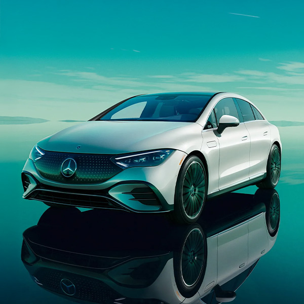 Front 3/4 shot of the 2025 Mercedes-Benz EQE Sedan parked on reflective ground