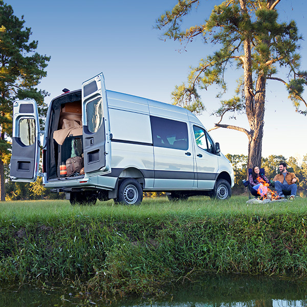 Rear 3/4 shot of the 2025 Mercedes-Benz Sprinter Crew parked with rear doors open