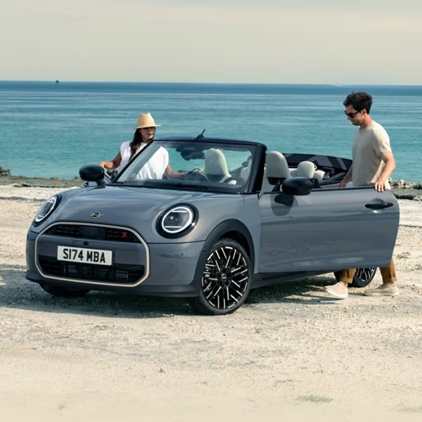 2025 MINI Convertible at a beach with couple getting into it