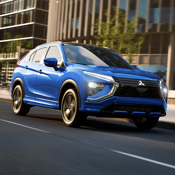 2025 Mitsubishi Eclipse Cross pictured in motion driving through a city