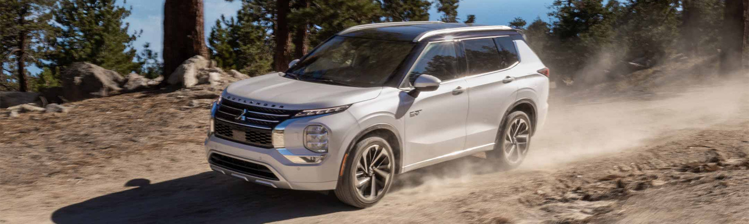 2025 Mitsubishi Outlander PHEV SUV on a dirt road