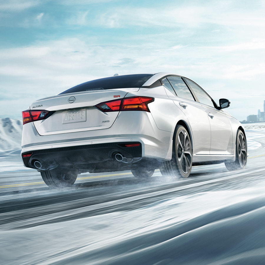 2025 Nissan Altima SR, Pearl White TriCoat, 3/4 rear, action, snow