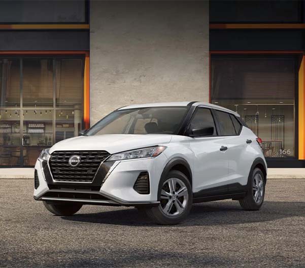 A white 2025 Nissan Kicks Play parked in an open lot