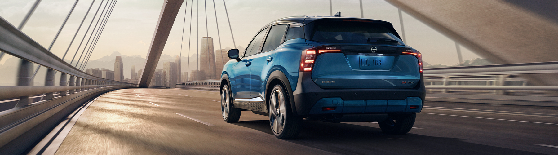 2025 Nissan Kicks SR AWD Premium Package, Two-tone Arctic Ice Blue Metallic/Super Black, exterior, 3/4 rear, driving