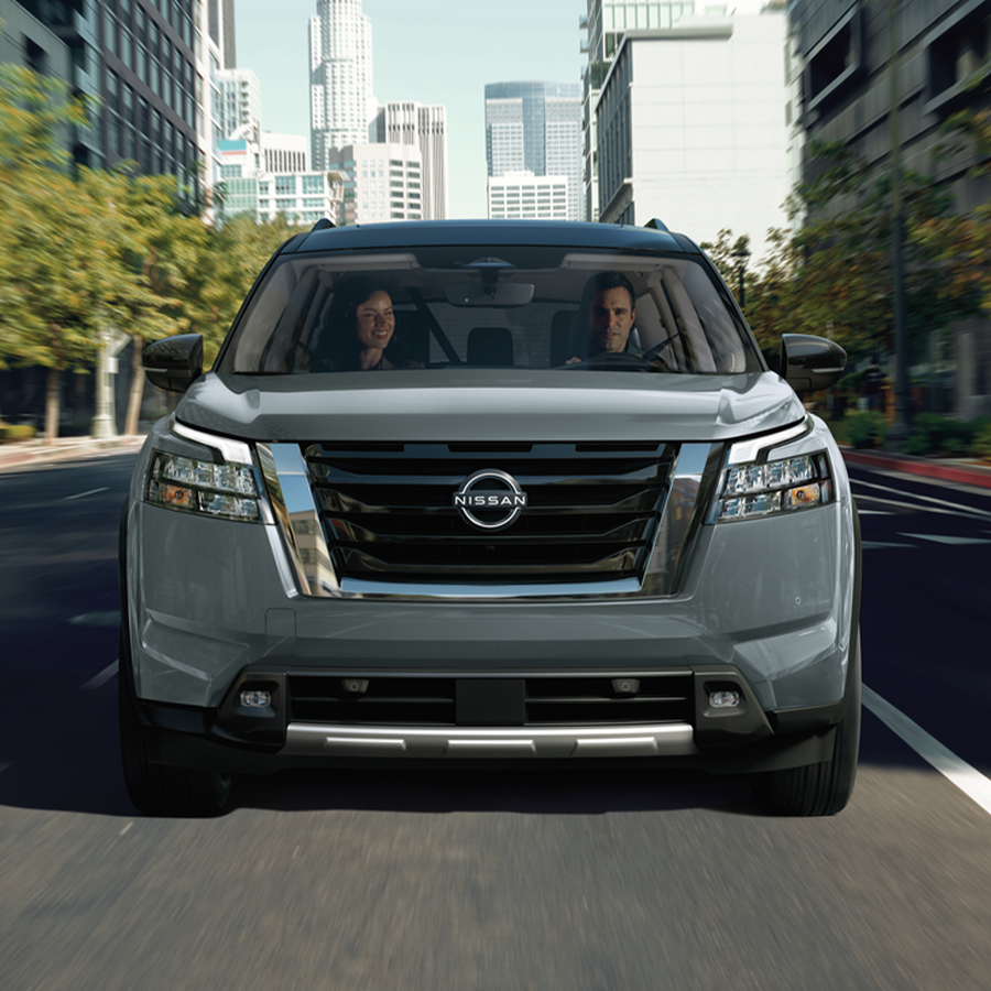 2025 Nissan Pathfinder driving down a city road