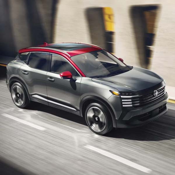2025 Nissan Kicks driving under overpass.