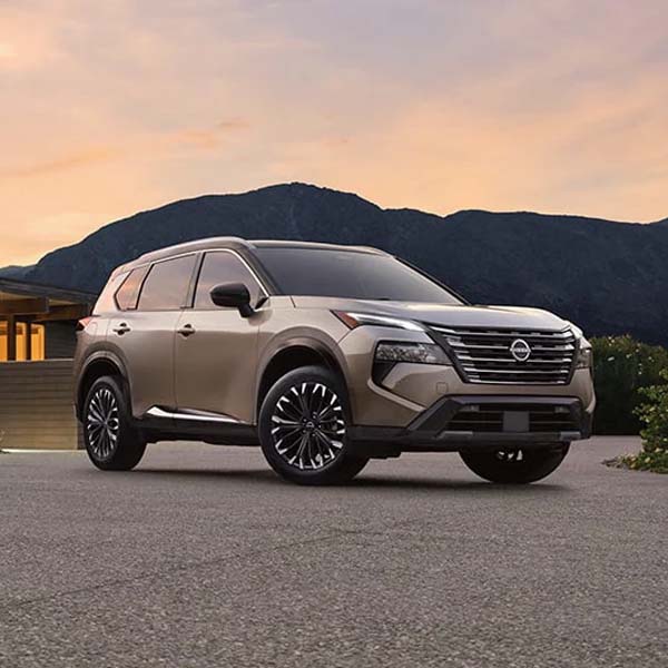 2025 Nissan Rogue parked near mountains.