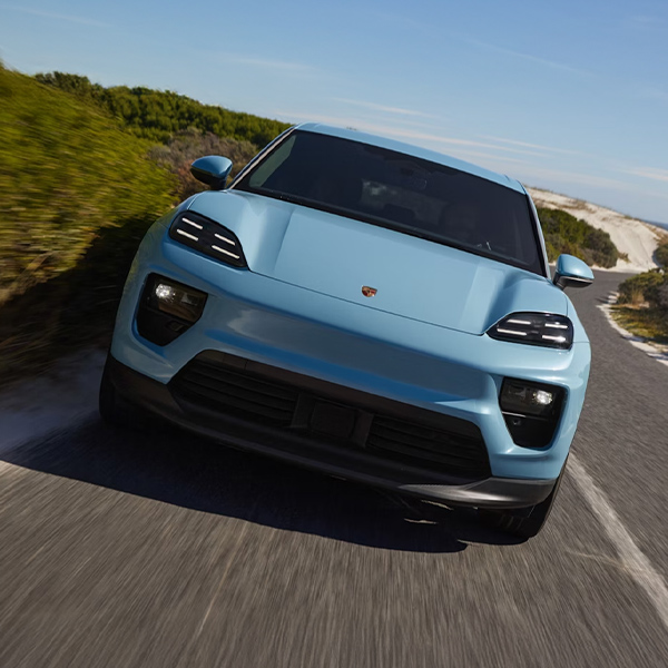 Porsche Macan 4 in Provence driving through the suburbs. Side and front visible.