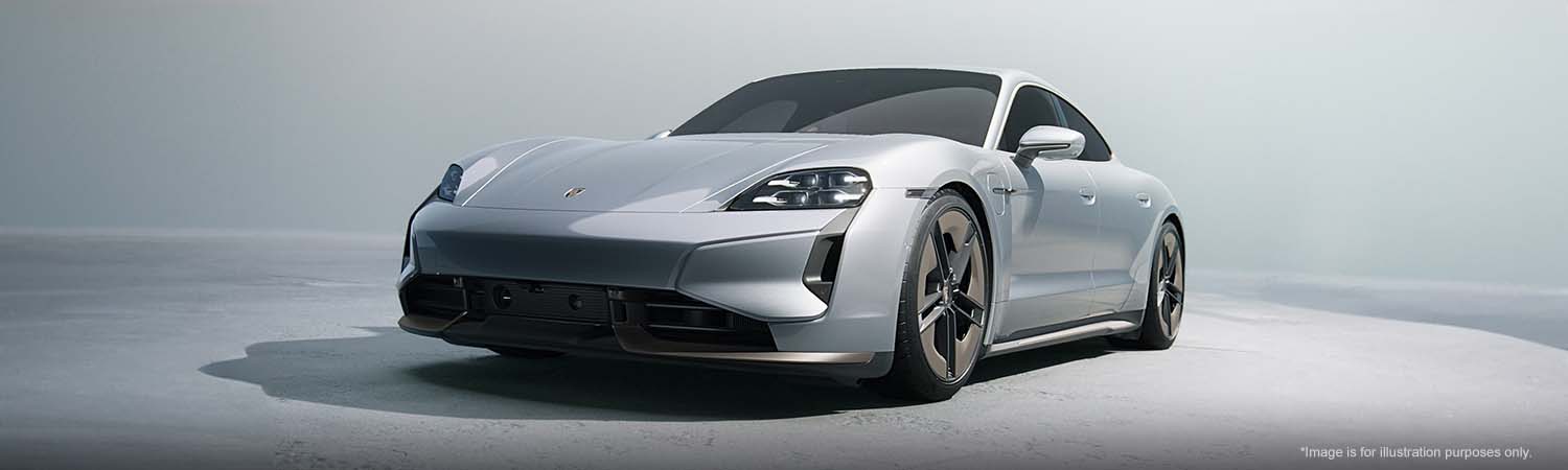 Porsche Taycan parked in a bright studio.