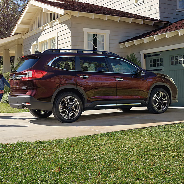 Side profile shot of the 2025 Subaru Ascent parked in driveway of home