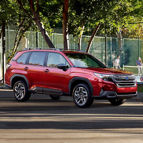 The 2025 Subaru Forester parked in front of a tennis court