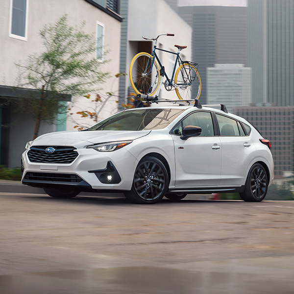 Front 3/4 shot of the 2025 Subaru Impreza turning onto street