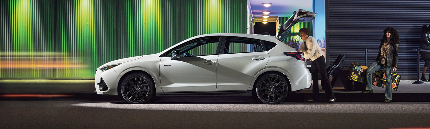 Side profile shot of the 2025 Subaru Impreza being unloaded on side of street