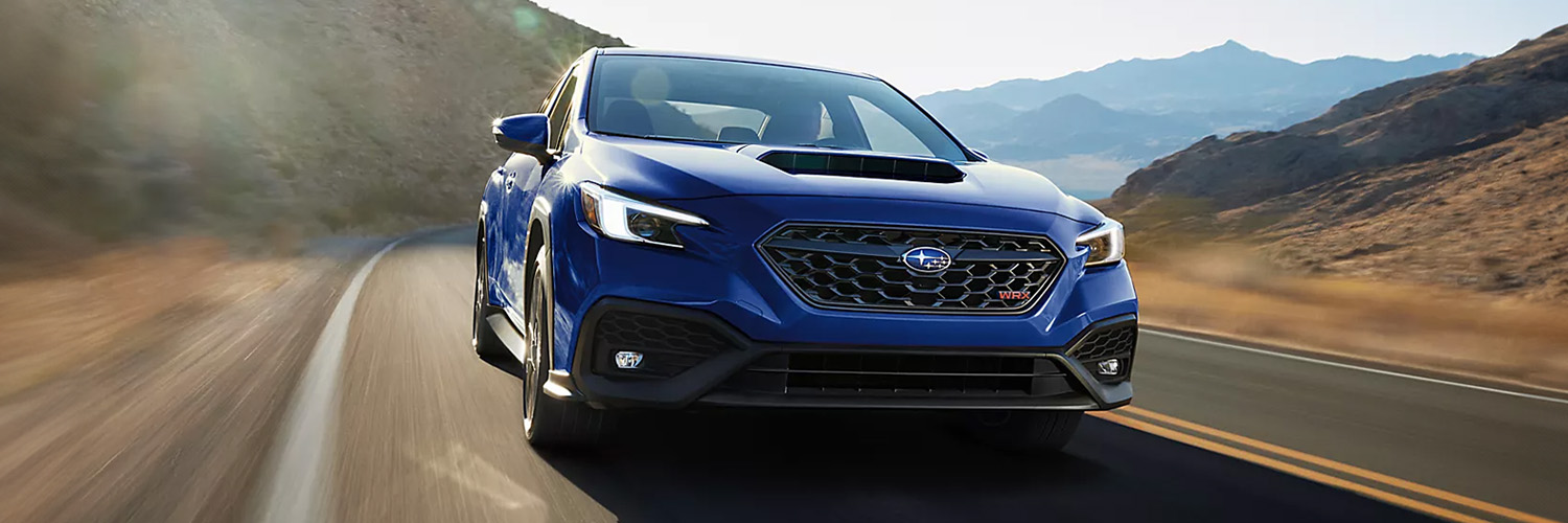 Exterior shot of a 2025 Subaru WRX driving in a desert.