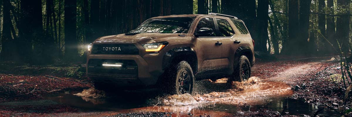 2025 Toyota 4Runner driving in muddy forest