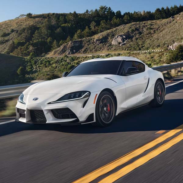 White Toyota Supra driving on the road