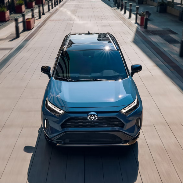 2025 Toyota RAV4 Hybrid XSE shown in Cavalry Blue with Midnight Black Metallic roof with Advanced Technology Package and panoramic glass roof.