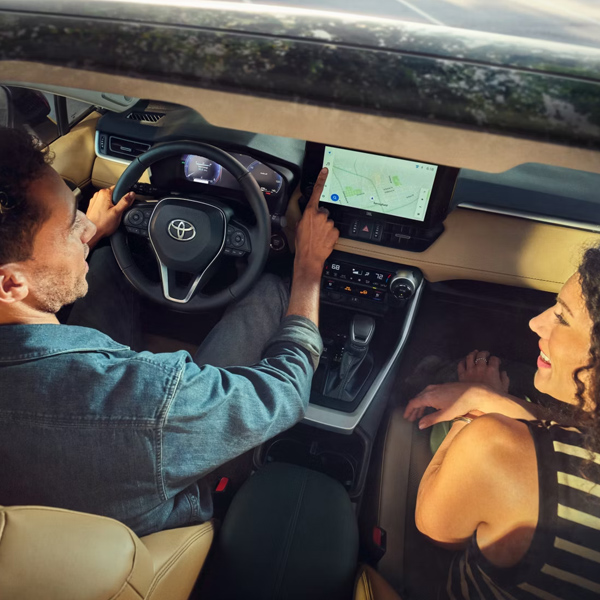 2025 Toyota RAV4 Limited interior shown in Nutmeg SofTex® trim with panoramic moonroof. Prototype shown with options.