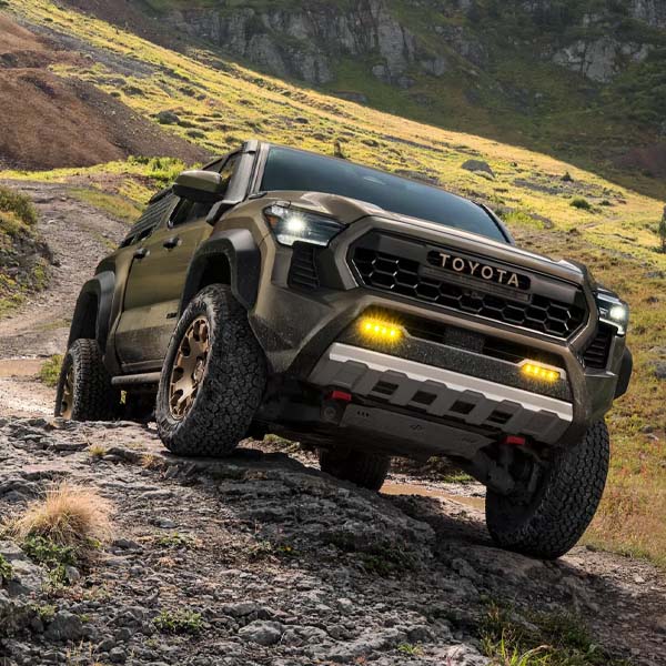 2025 Toyota Tacoma driving along a rocky road
